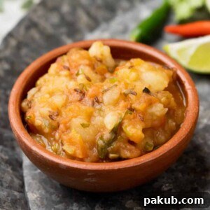 Picture of potato curry served in a brown terracotta bowl