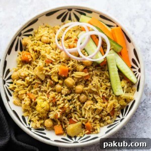 Kabuli Chana Pulao served in a bowl with onions and a salad