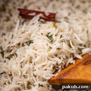 a close up image of jeera rice to show it's fluffy texture
