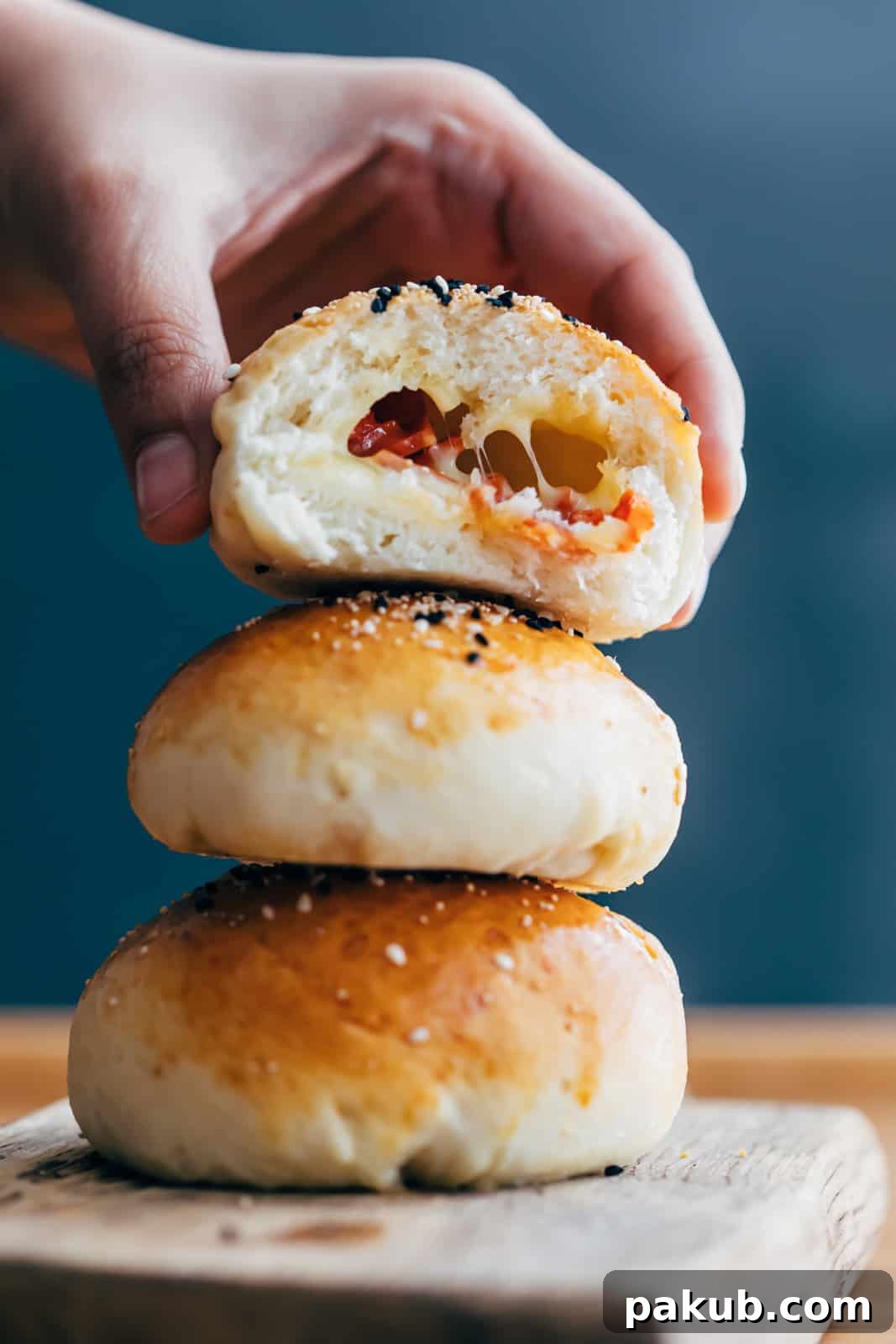 Melt-in-Your-Mouth Pepperoni Cheese Bombs 2 Bite shot of pepperoni cheese bombs showing the stuffing with melted cheese and pepperoni