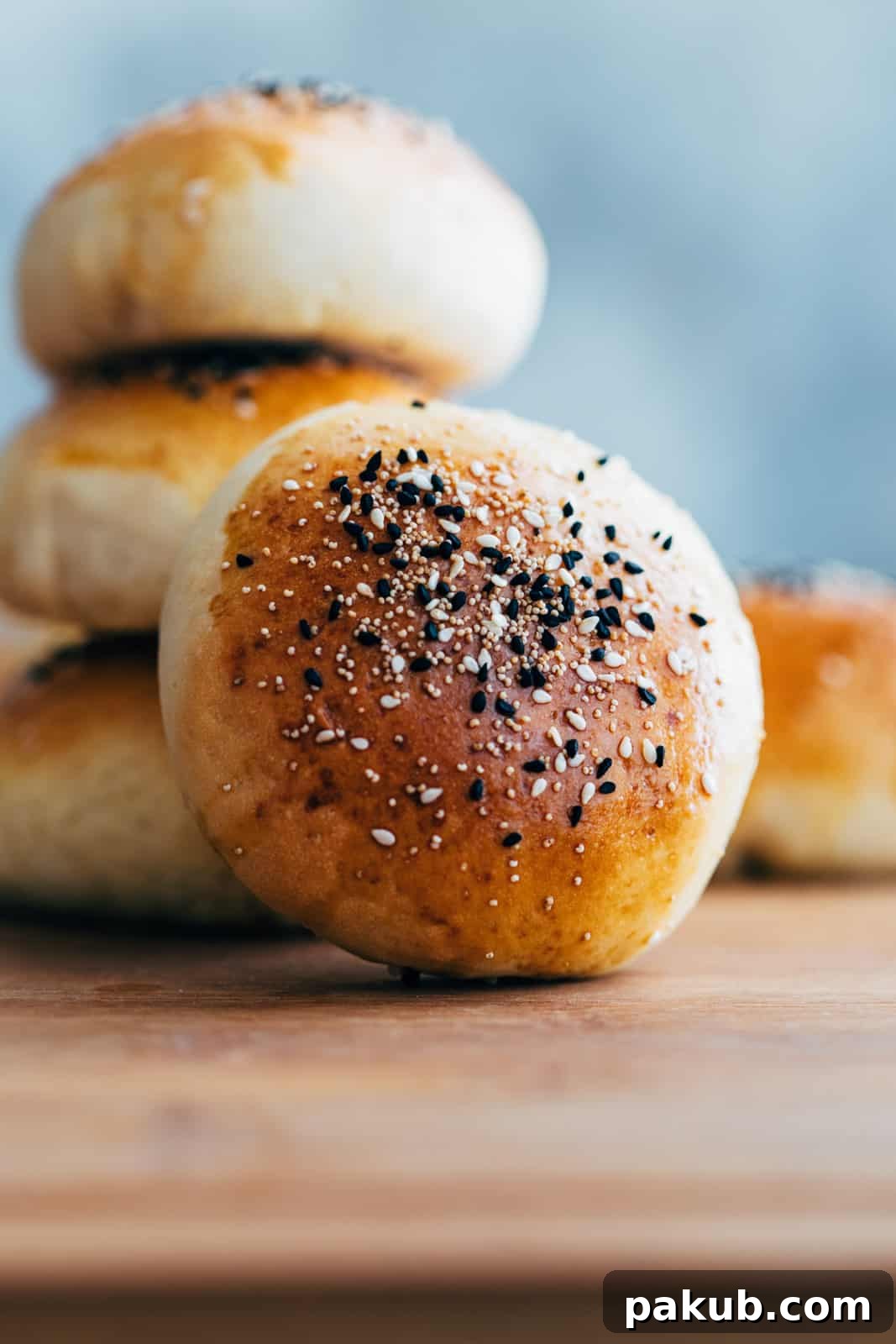 Melt-in-Your-Mouth Pepperoni Cheese Bombs 3 Cheese pepperoni bombs stacked on a serving board with a rustic background