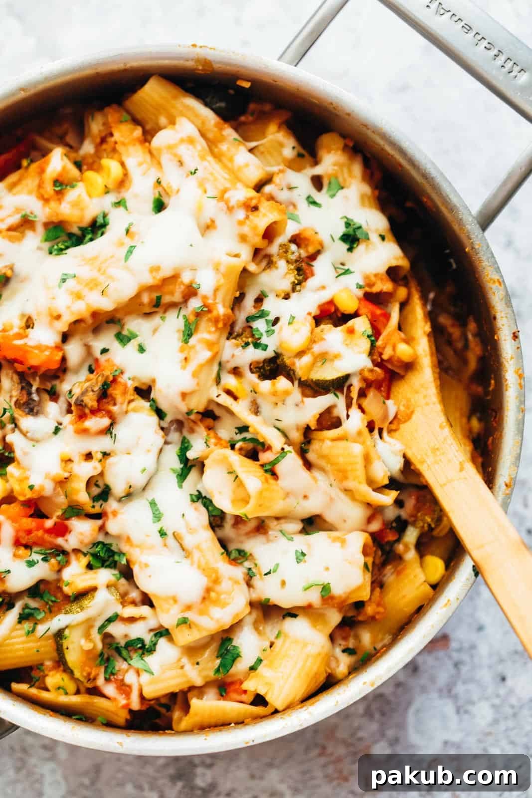 Vibrant one-pot vegetable pasta simmering in a large pan, straight from the stove, showcasing colorful vegetables and pasta in a rich sauce.