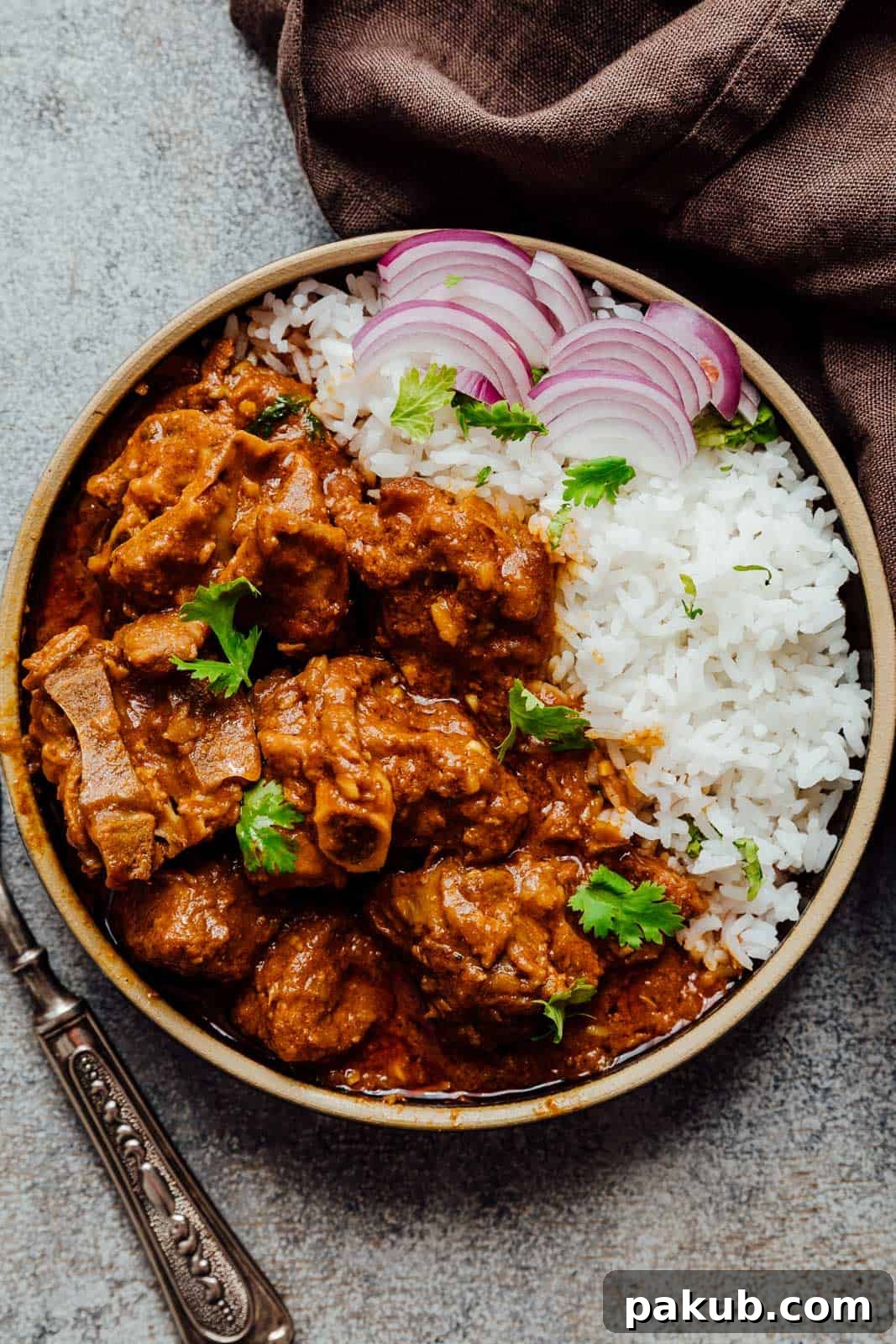 Melt-In-Your-Mouth Slow Cooker Lamb Curry 4 Close-up of slow cooker lamb curry garnished with fresh cilantro, steam rising, highlighting its rich texture and vibrant colors.