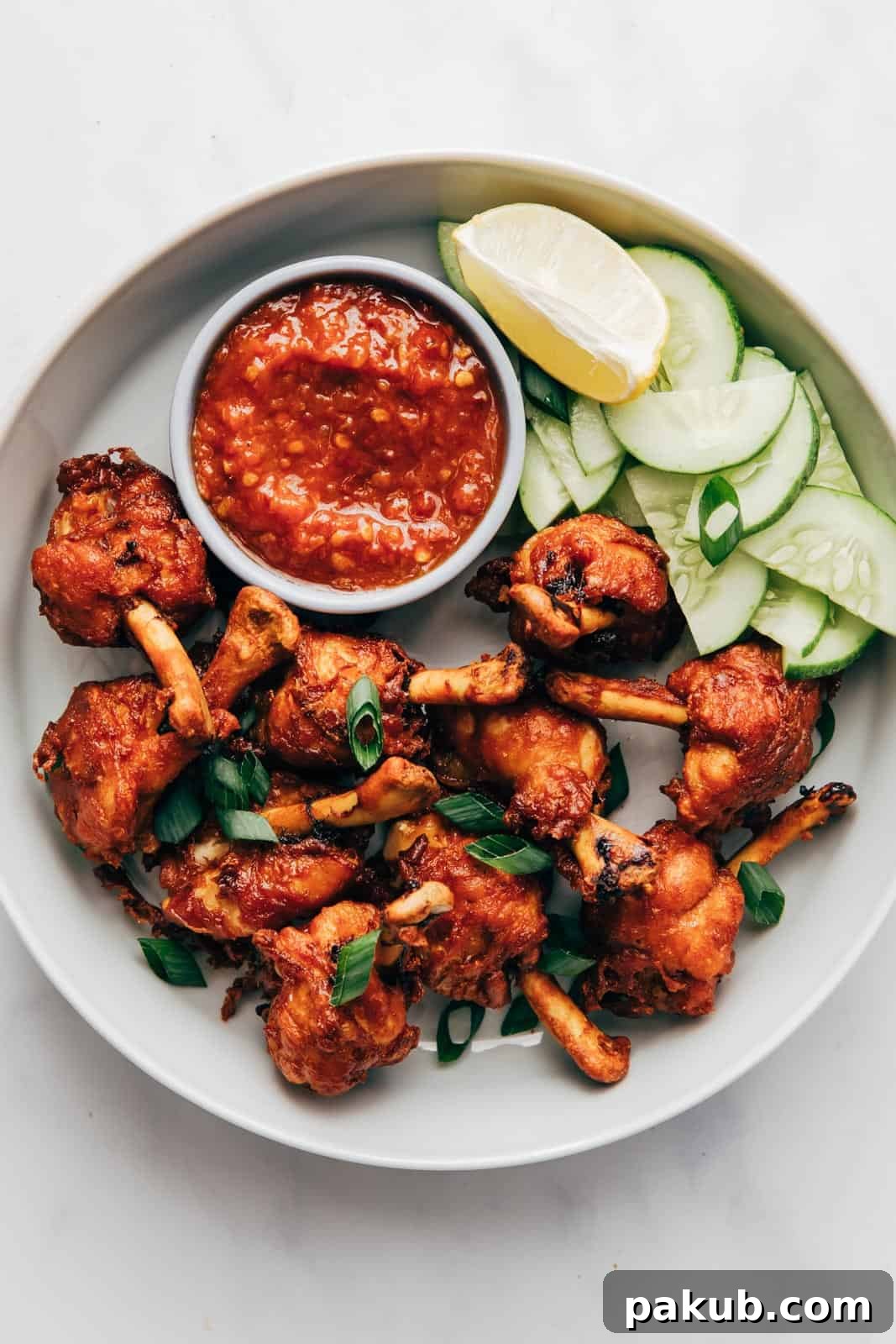 Fried chicken lollipops ready to be served with schezwan sauce
