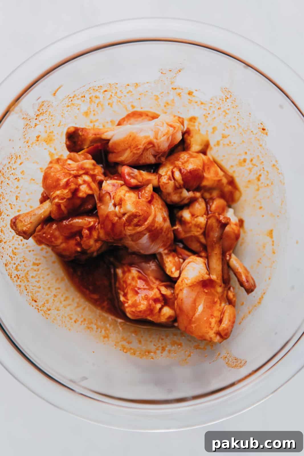 Chicken lollipop marinating in a bowl