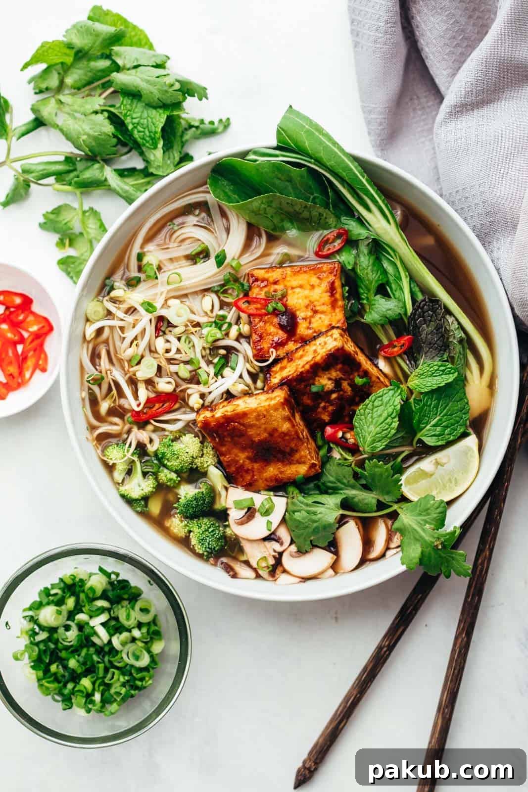 Plant-Powered Pho Bowl 2 Hearty Vegetarian Pho soup served in a bowl with fresh toppings like cilantro, lime, and bean sprouts, showcasing vibrant colors and rich broth.