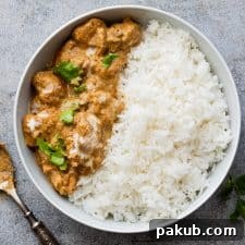 Easy chicken korma served in a bowl with rice