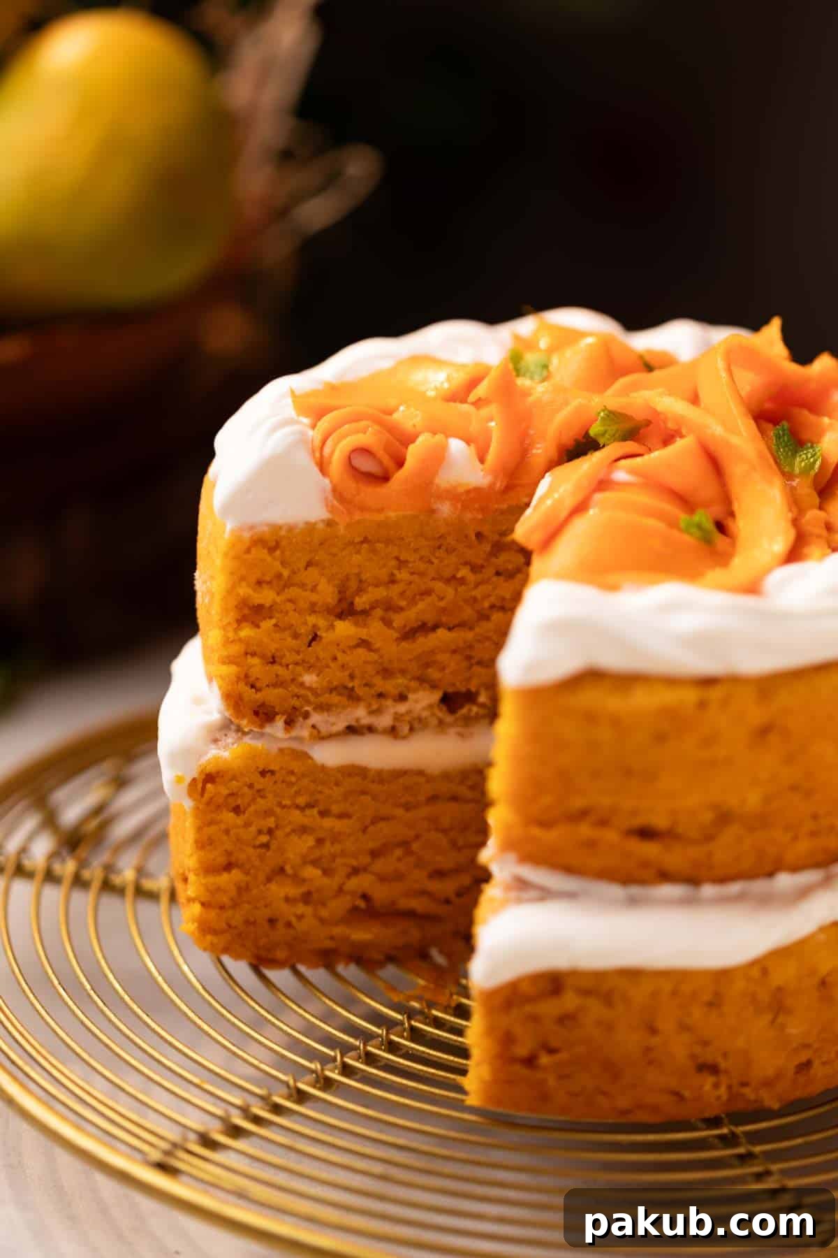 Sunshine Mango Delight 2 A beautifully decorated eggless mango cake on a cake stand, topped with fresh mango chunks and whipped cream.