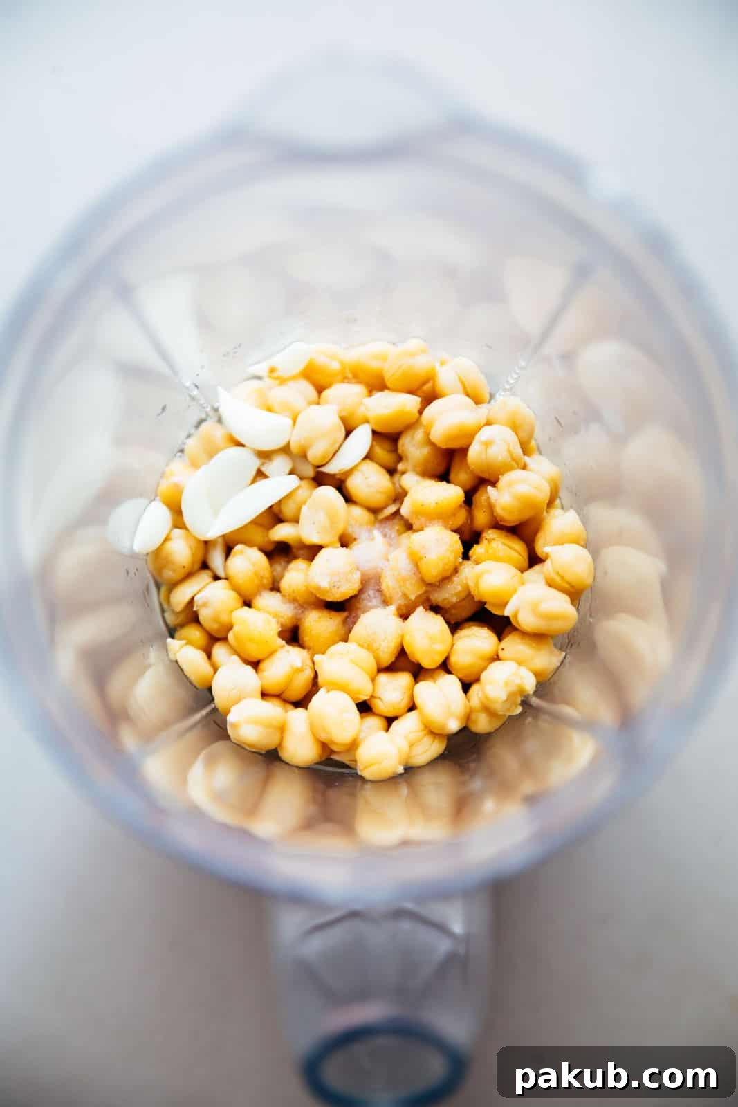 Whip Up Perfectly Light and Fluffy Homemade Hummus 4 Add chickpeas, garlic, salt to a blender