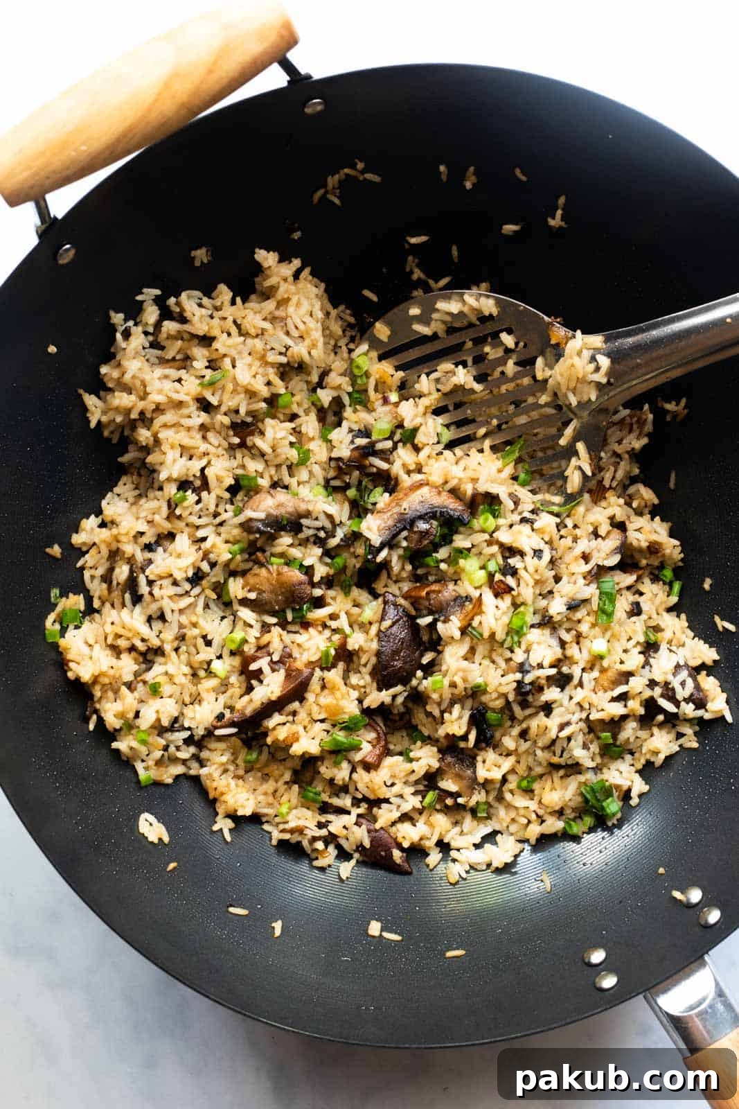 Roasted Garlic Mushroom Fried Rice 2 Burnt garlic mushroom fried rice ready in the wok, showing a vibrant mix of rice and sautéed mushrooms.