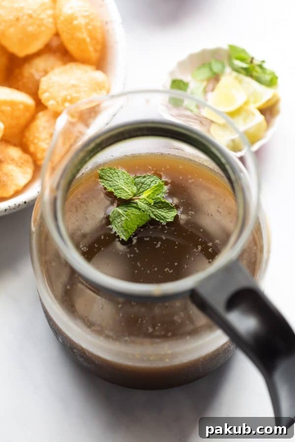 Effortless Homemade Pani Puri 5 Jaljeera served in a jar, ready to be poured into pani puris
