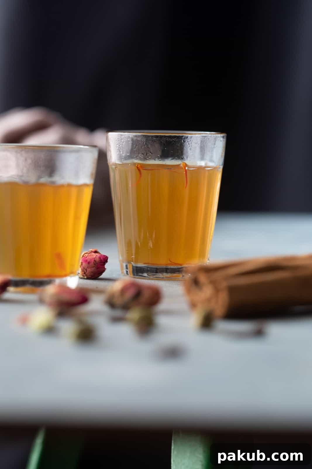 Chai Secrets Revealed 5 Recipes to Master 10 Exotic Kashmiri Kahwa served in small, clear tea glasses with visible saffron strands and spices.