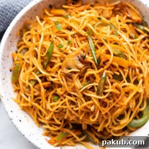Chilli Garlic noodles served in a white textured bowl, ready to be enjoyed.