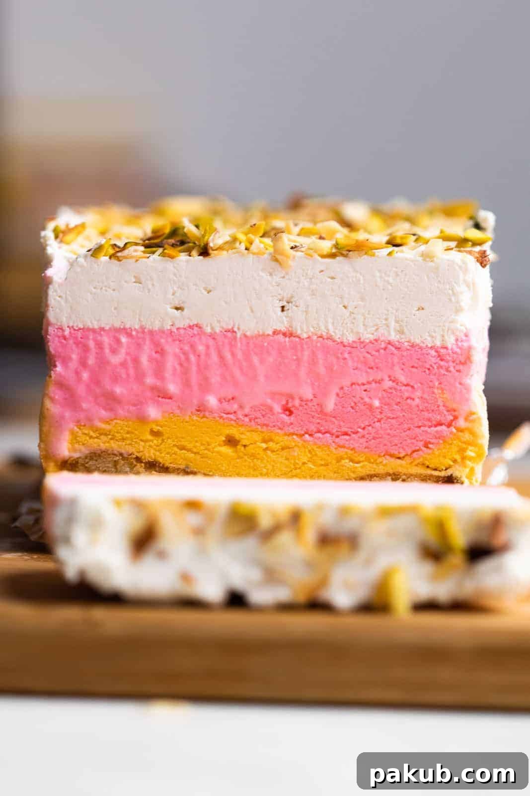 Modern Cassata Cheesecake 2 A beautifully sliced Classic Cassata on a kitchen worktop, showcasing its vibrant layers of cake, ice cream, and creamy cheesecake.