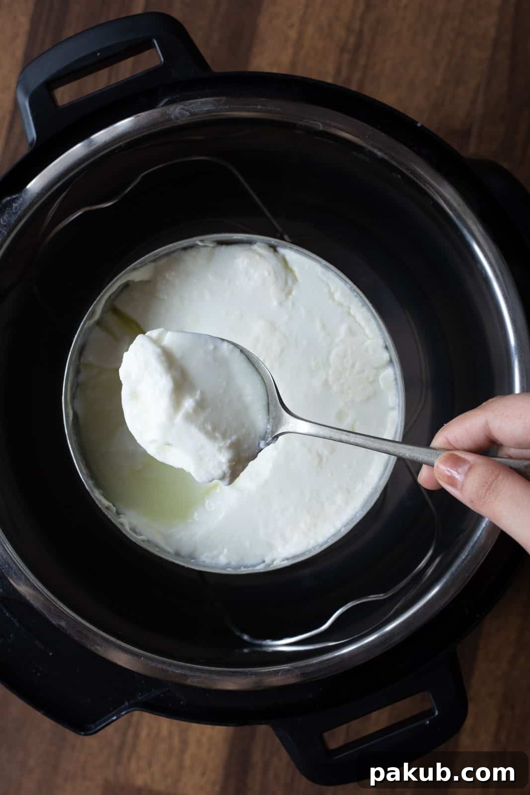 Pot in pot method used to make yogurt in the Instant Pot. Picture showing the consistency of yogurt made using this method