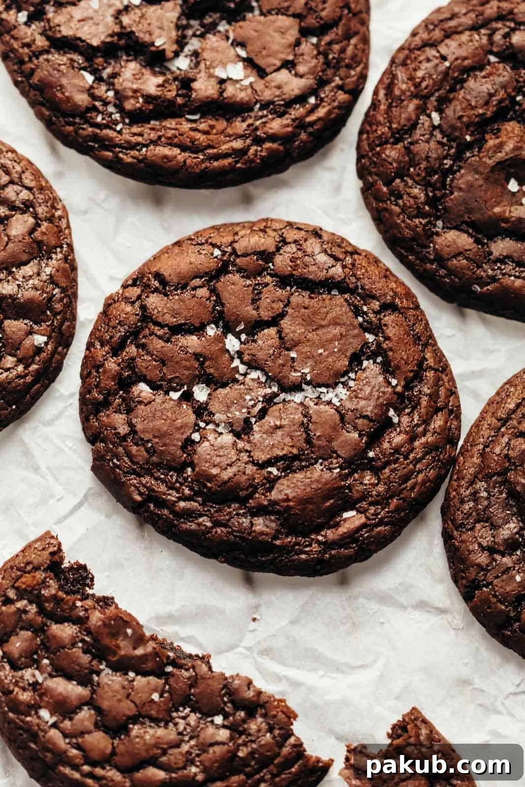 The Ultimate Fudgy Brownie Cookie for Your Inner Monster 2 Brownie Cookies sprinkled with sea salt and placed on a tray lined with parchment paper