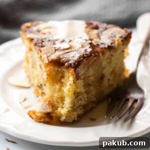 Close up of a slice of dundee cake to showcase the moist crumb