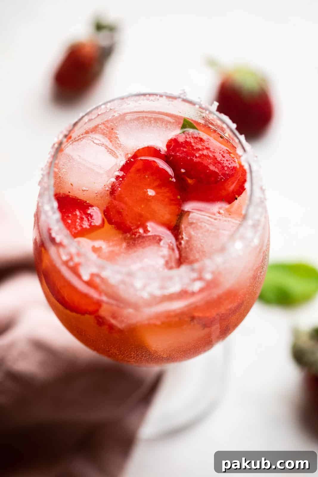 Peppered Strawberry Gin Tonic 2 Strawberry Pepper Gin and Tonic served in a short stemmed glass with sugar on the rim