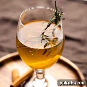 Hot toddy served in a short stemmed glass on a brown plate