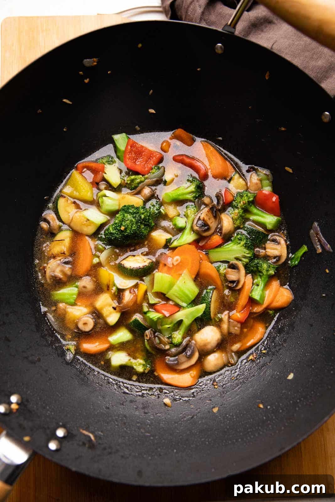 Effortless Asian Veggie Perfection 3 Picture of Asian Vegetable Stir Fry in a wok, showing crisp vegetables and shimmering sauce