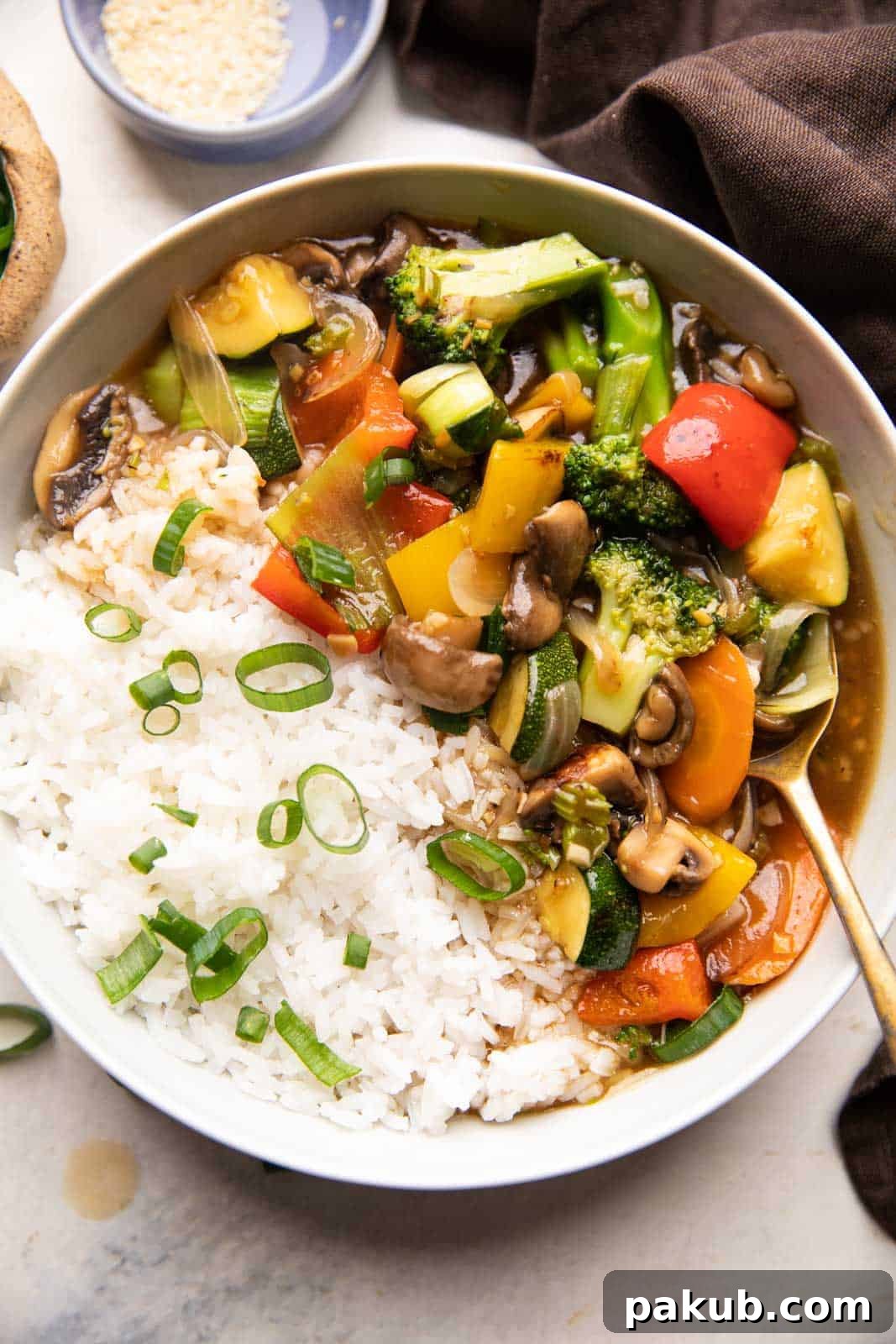 Effortless Asian Veggie Perfection 4 Picture of Asian Vegetable Stir Fry served with rice in a bowl, ready to enjoy