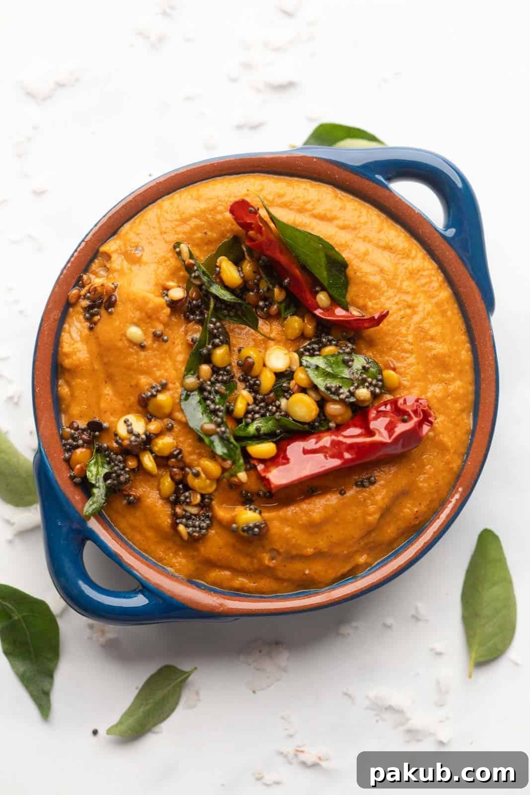 Unlocking Flavor: Chutneys for Idlis and Dosas 7 Tomato Chutney served in a blue bowl with tempering on top