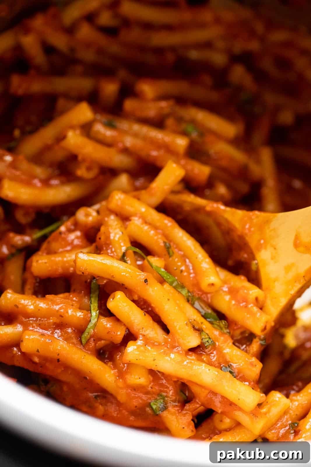 Closeup of pasta being scooped up in a ladle in the instant pot