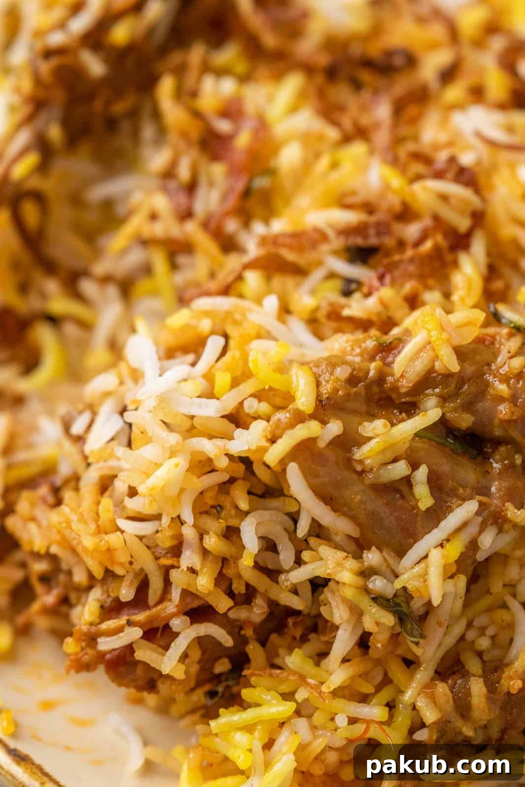 Mouthwatering Mutton Biryani Made Easy 5 Closeup of the grains of rice and a piece of mutton from the mutton biryani