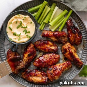 Spicy BBQ Chicken Wings on a hammered silver plate with aioli and celery on the side