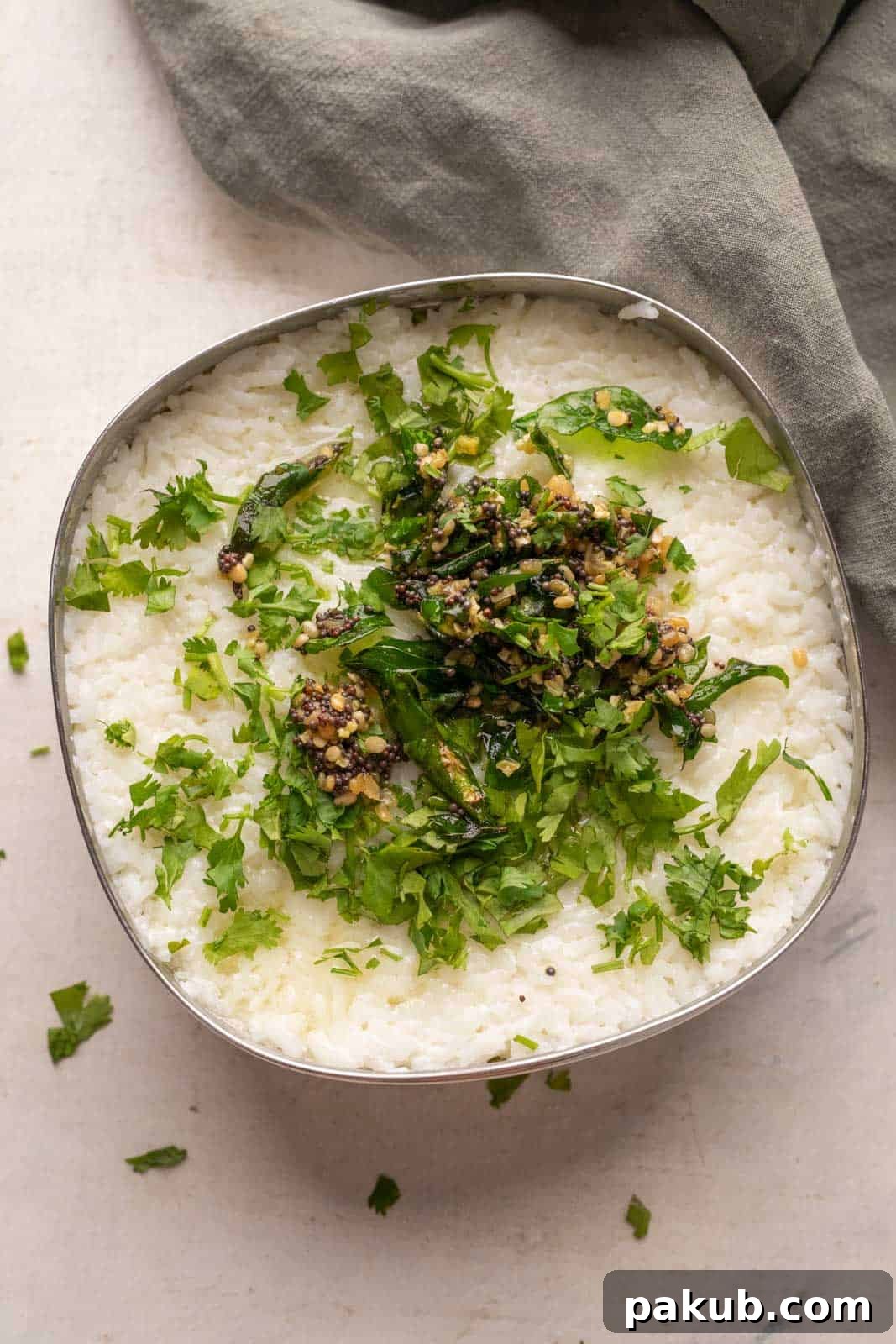 Curd rice set in a steel bowl topped with tempering and chopped coriander, indicating Method 1