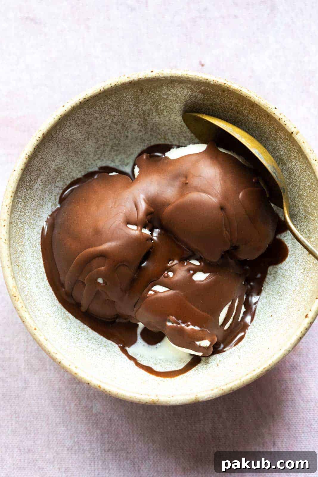 Effortless Two Ingredient Chocolate Magic Shell 2 Vanilla ice cream with a perfectly hardened and crackly chocolate magic shell, served in a rustic brown ceramic bowl with a spoon, showcasing the tempting texture