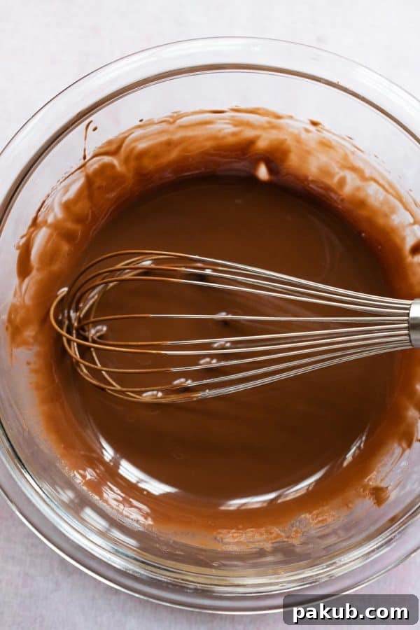 Effortless Two Ingredient Chocolate Magic Shell 4 Smooth and glossy melted chocolate and coconut oil mixture, showcasing the perfect consistency before pouring over ice cream