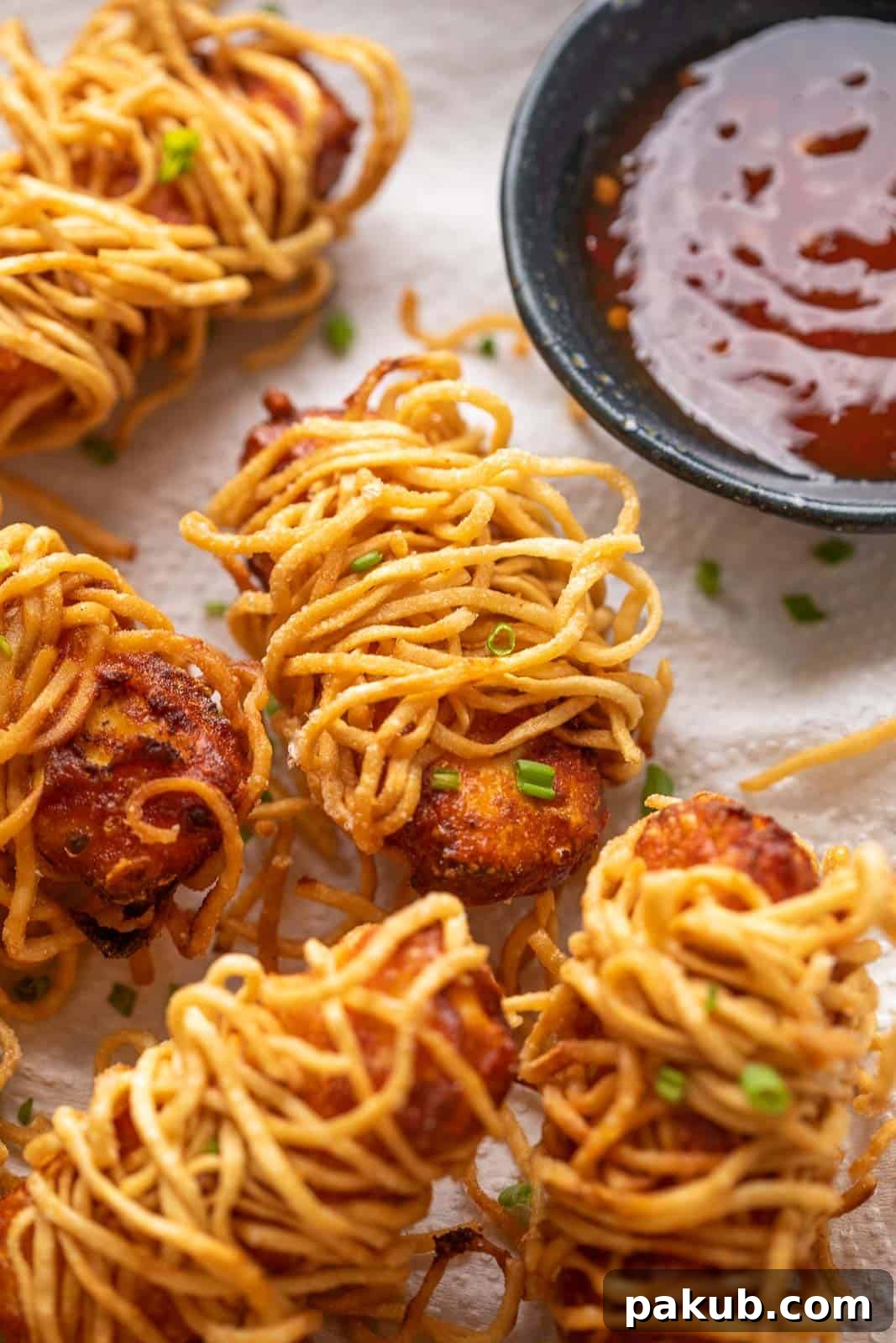 Golden Thread Paneer Bites 2 Crispy Thread Paneer served on a tissue paper-lined plate with a side of sweet chili sauce