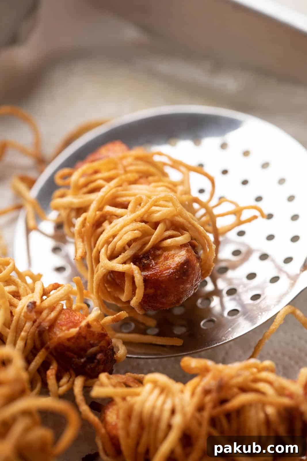 Golden Thread Paneer Bites 7 Freshly fried Crispy Thread Paneer pieces being removed from hot oil with a slotted spoon