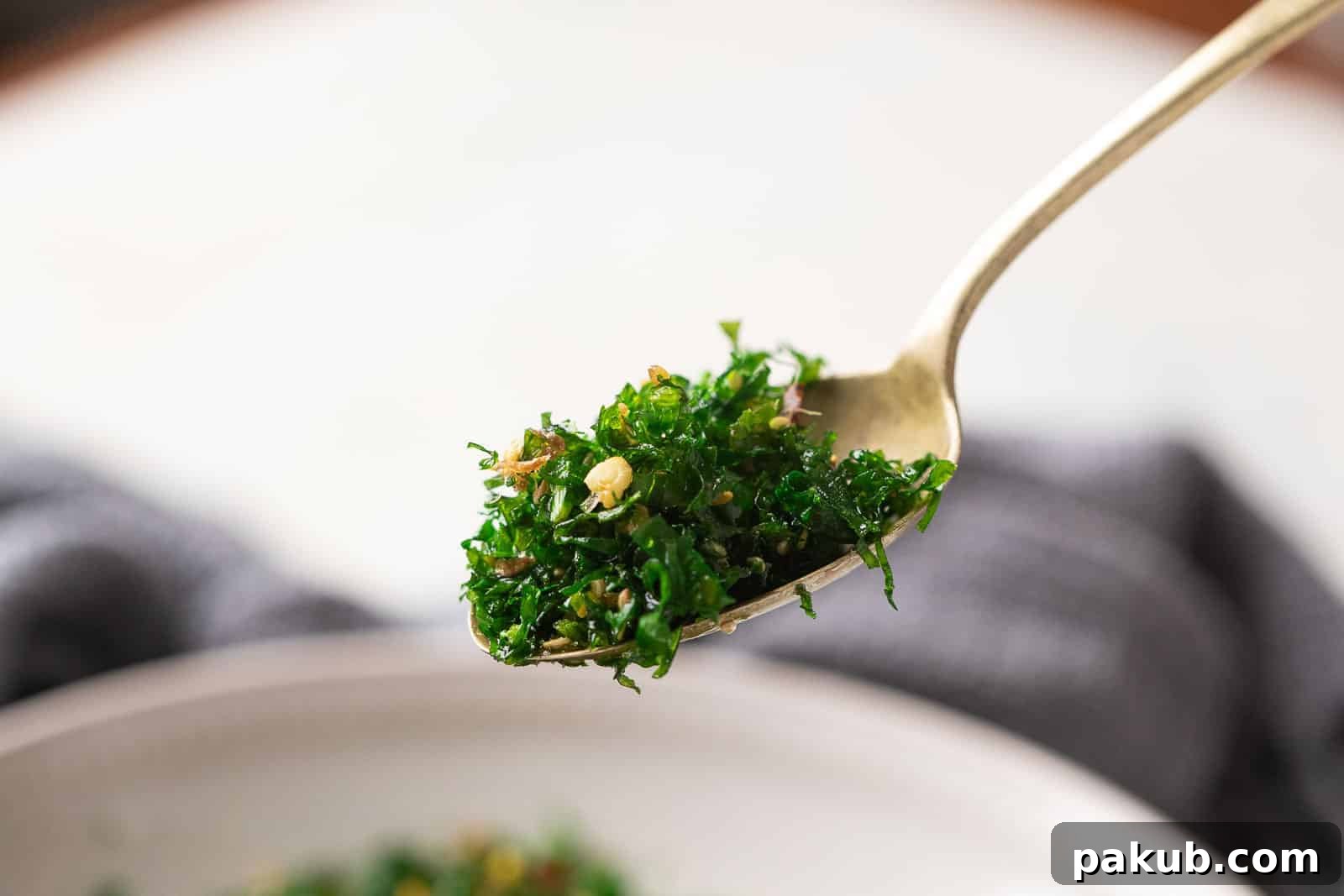 Crispy fried spinach served in a spoon, ready to eat