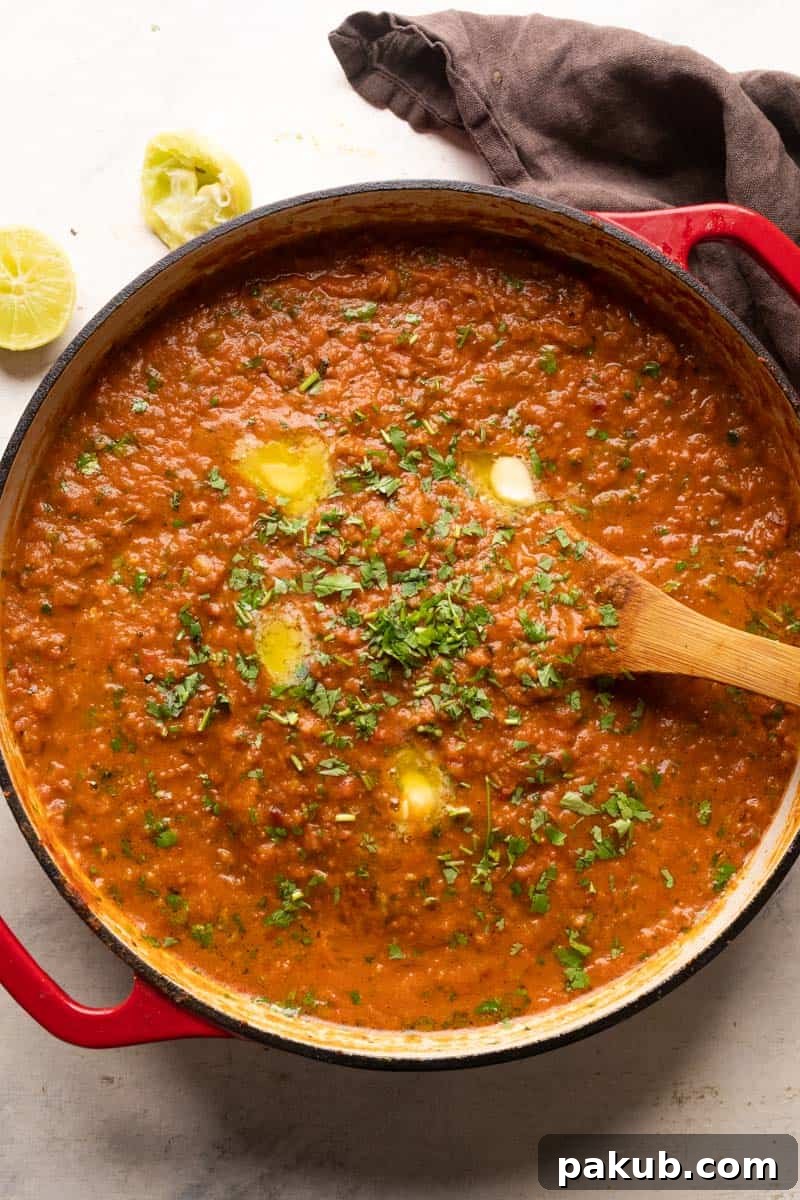 Mumbai Style Pav Bhaji Recipe 3 Pav Bhaji served in a large red shallow pan in which it was cooked with a wooden ladle