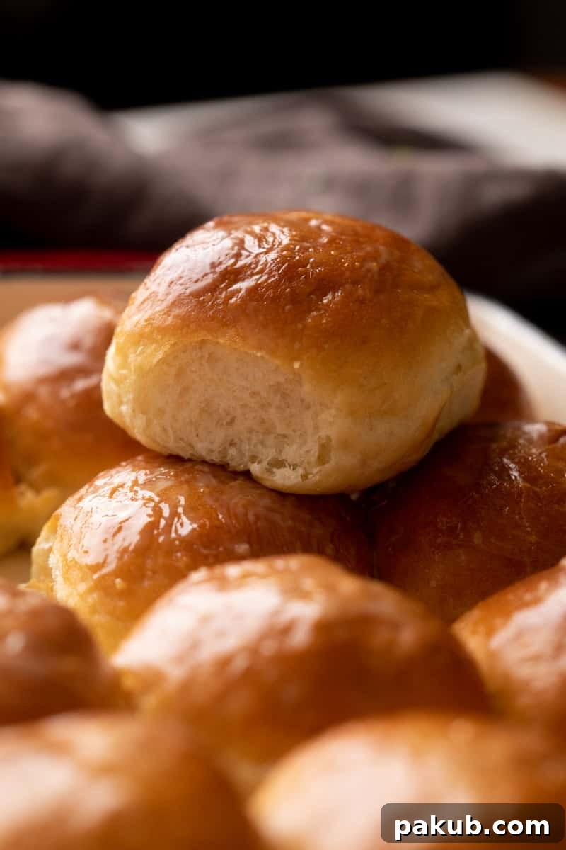 Soft Eggless Mumbai Ladi Pav 2 Single ladi pav stacked on top of other baked ladi pavs, showcasing its soft texture