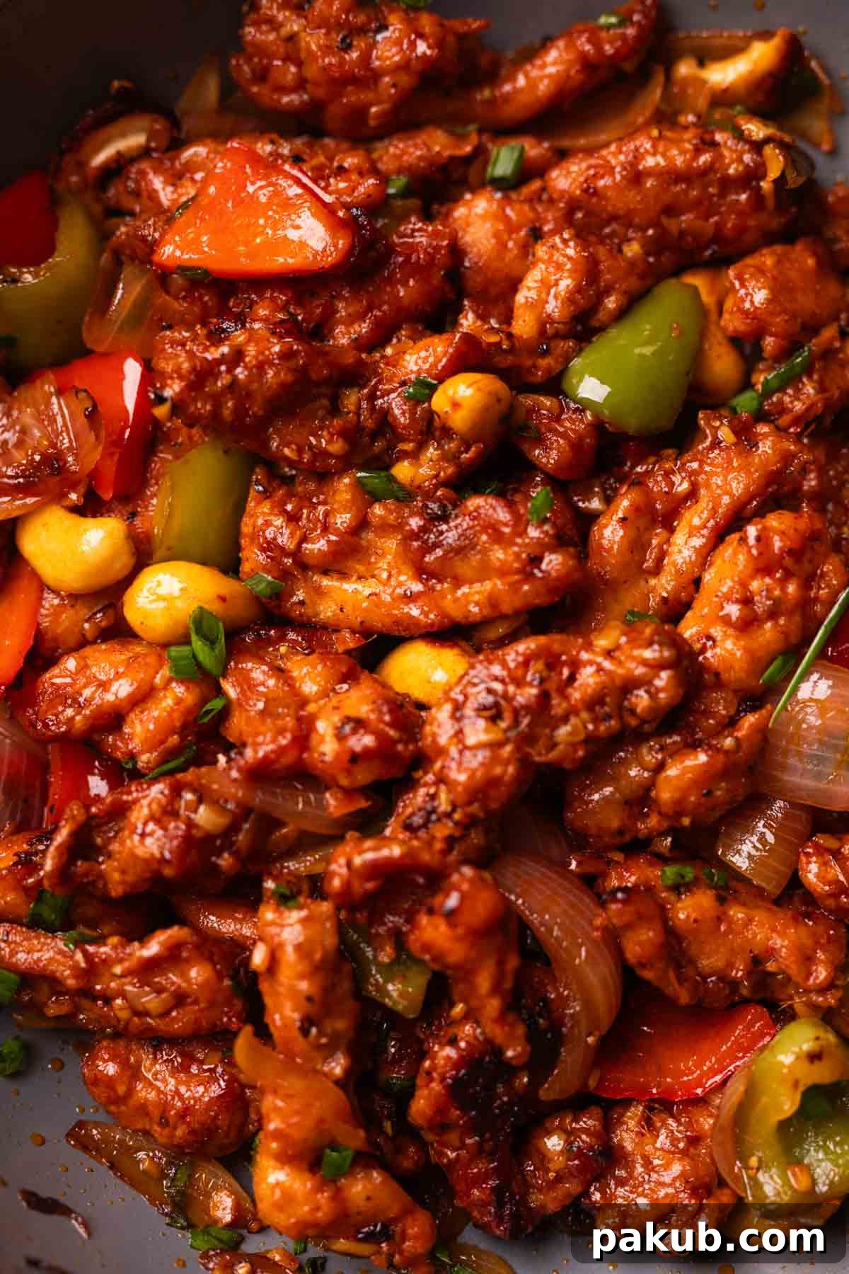A close up image of dragon chicken to show its texture and glistening sauce