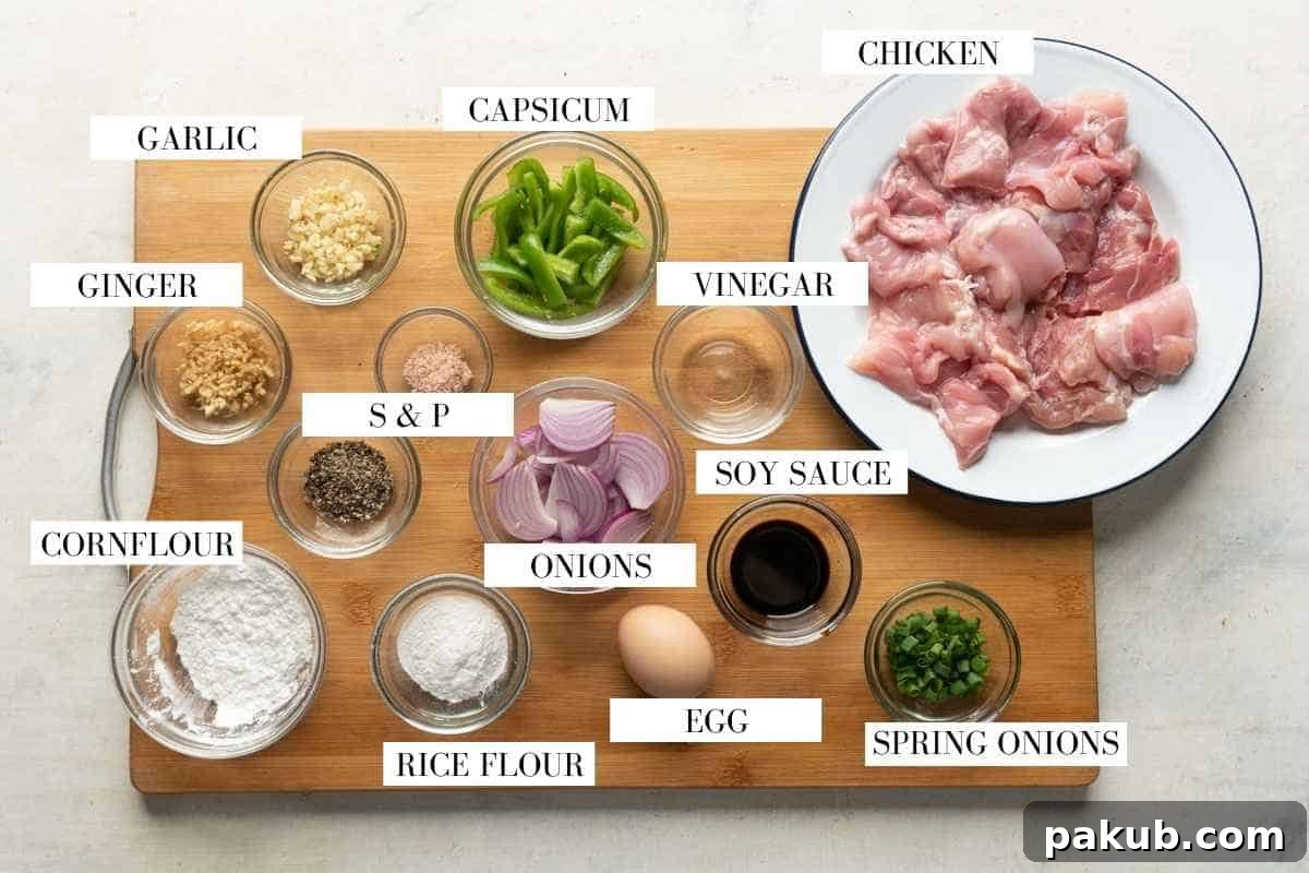 Salted Pepper Chicken Delight 3 All the ingredients for salt and pepper chicken laid out a wooden board with text to identify them