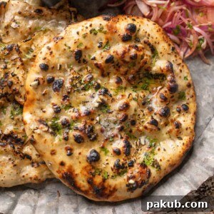 Closeup of kulcha brushed with butter on a plate