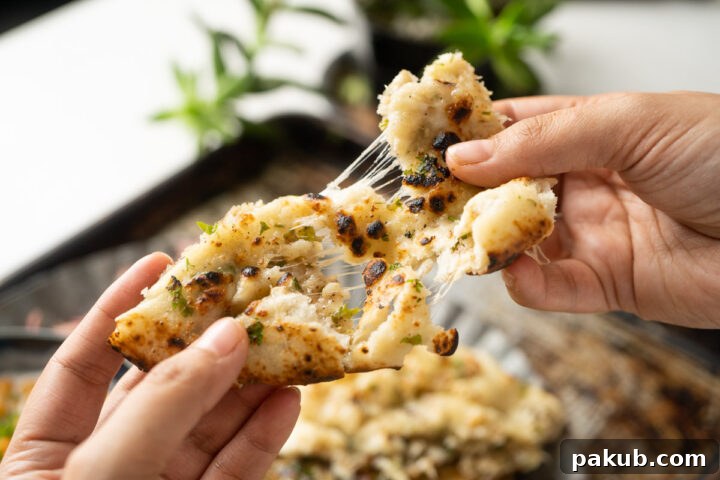 Picture of a cheese pull to show how the kulcha is stuffed with cheese
