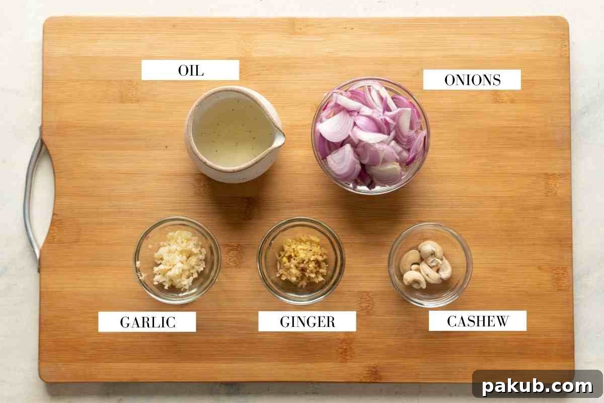 Ingredients for making the onion paste for chicken kali mirch on a brown board with text to identify them