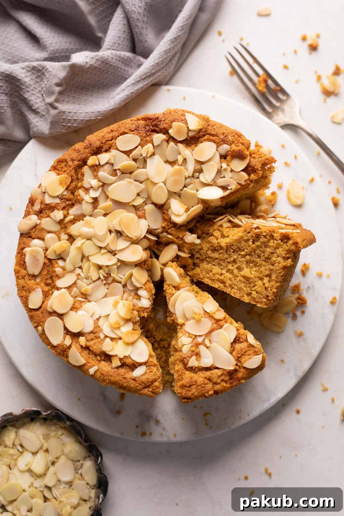 Mawa cake sliced and served on a white platter