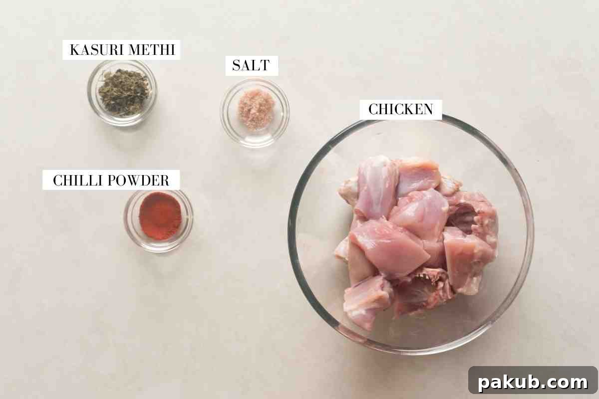 Saag Palak Chicken Recipe 3 Ingredients for marinating chicken, including chicken pieces, red chili powder, kasuri methi, and salt, laid out for preparation.