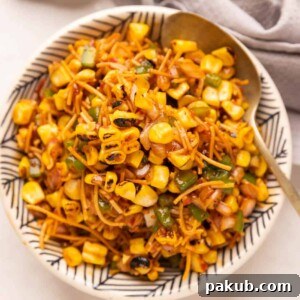 Corn Bhel served in a cowl with a spoon on the side