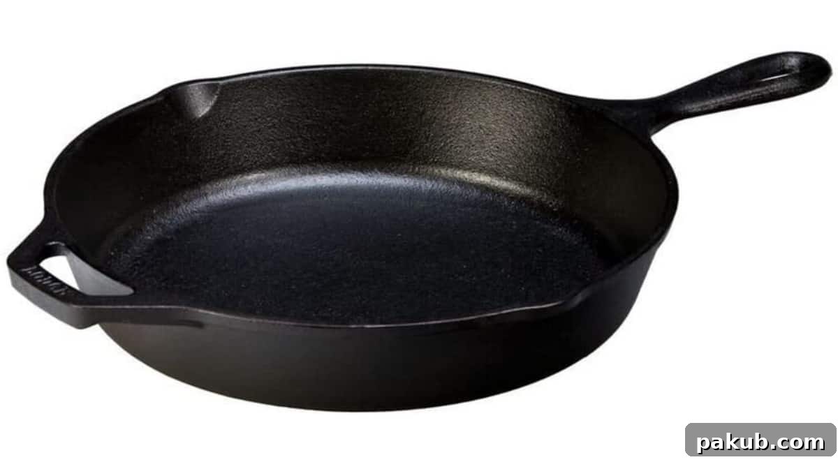 My Favorite Kitchen Workhorses of 2022 11 A perfectly seasoned cast iron pan, showcasing its robust build and readiness for high-heat cooking, an enduring symbol of traditional culinary excellence.