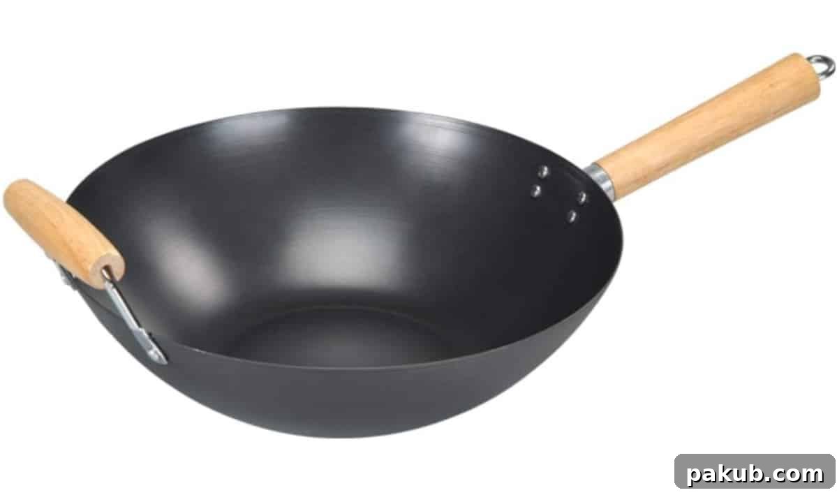 My Favorite Kitchen Workhorses of 2022 4 A pristine, gleaming wok ready for cooking, illustrating its essential role in Asian cuisine and high-heat cooking techniques.