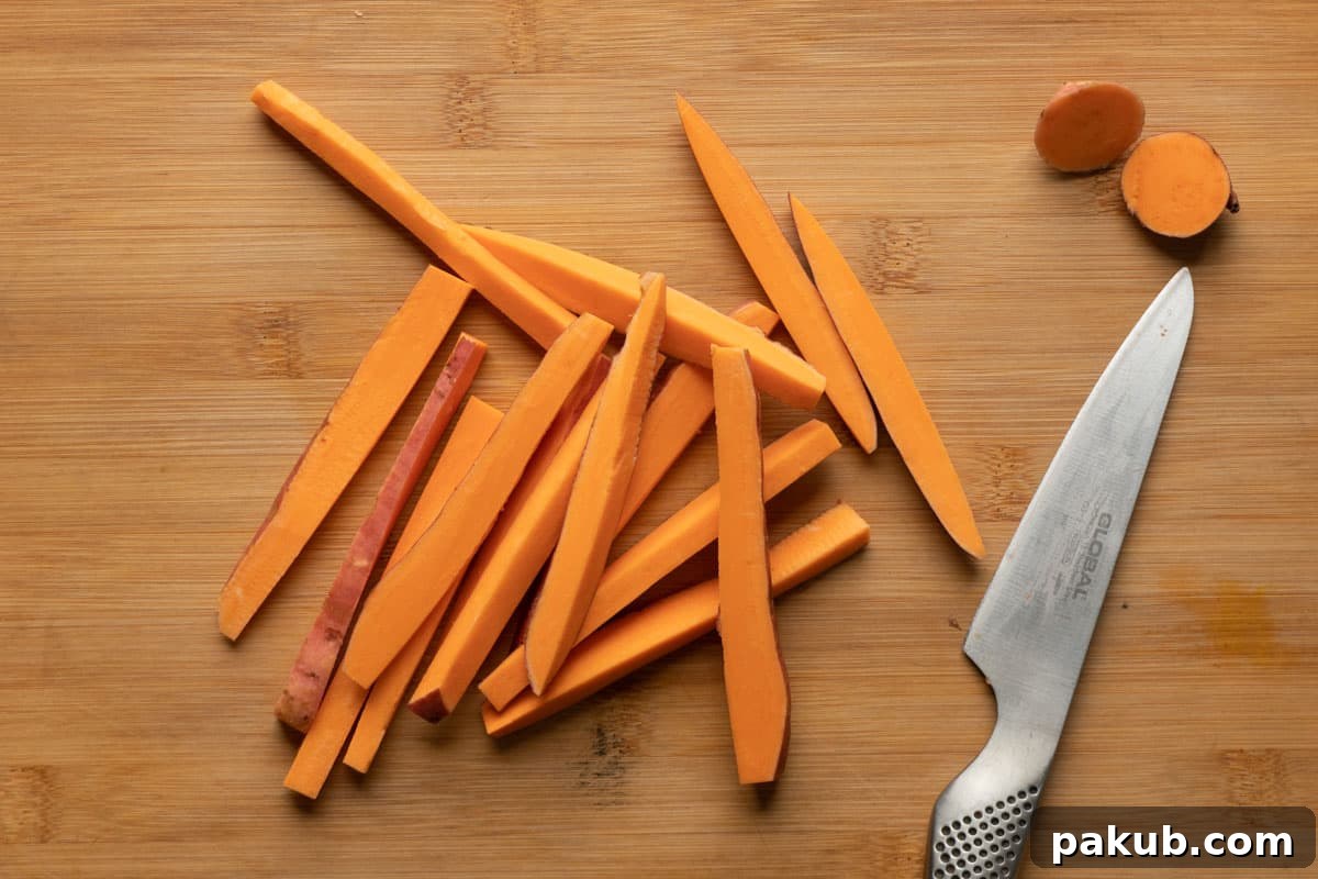 A perfectly prepared batch of evenly cut sweet potato fries, ready for seasoning