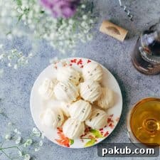 Elegant lavender white chocolate truffles arranged beautifully, garnished with sprigs of fresh lavender.