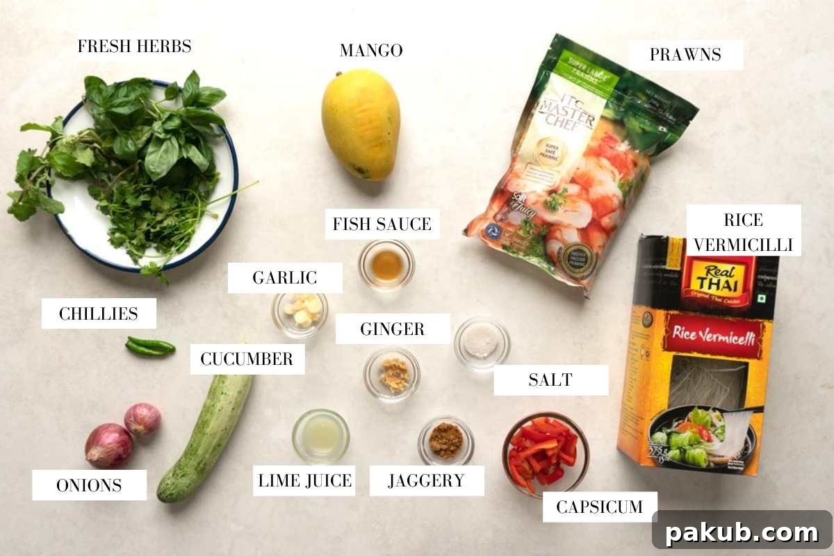 A beautiful flat lay of all the fresh ingredients needed for Thai Prawn Mango Salad, including prawns, sliced mango, various vegetables, and herbs, ready for preparation.